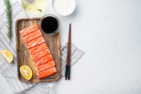 Fresh Crab meat stick surimi set, on wooden tray, on white background, top view flat lay, with copyspace and space for textの写真素材