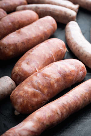 Traditional pork sausages, on black background.の写真素材