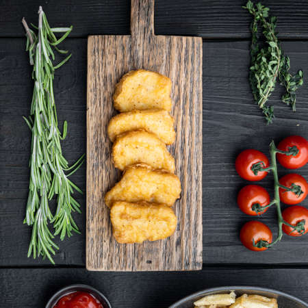 Nuggets breaded on black wooden background, flat lay.の写真素材