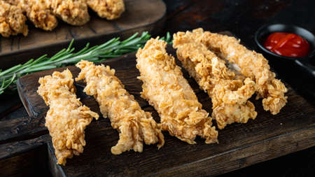 Deep fried crunchy spicy chicken meat on dark wooden background.の写真素材