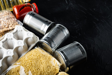Various canned food and raw cereal grains, grocery goods, delivery or donation with space for text,...