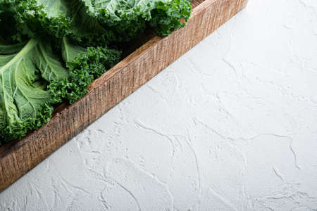 Green kale salad leaf set, in wooden box, on white background, with copyspace and space for textの写真素材
