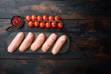 Traditional pork sausages, flat lay with space for text, on old dark wooden background.の写真素材