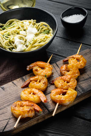Seafood spaghetti pesto ready to eat set, on black wooden table backgroundの写真素材