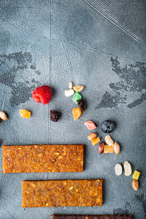 Dried fruits energy bars, flat lay with space for text, on gray background