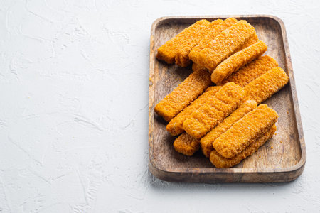 Frozen fish breadcrumbs set, on wooden tray, on white background, with copyspace and space for text