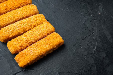 Frozen fish fingers set, on black background, with copyspace and space for textの写真素材