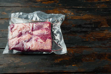 Vide sous vacuum beef brisket food set, on old dark wooden table background, top view flat lay, with copyspace and space for textの写真素材