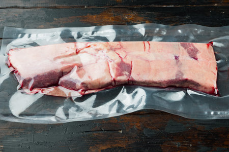 Vacuum packed meat Beef short rib set, on old dark wooden table background