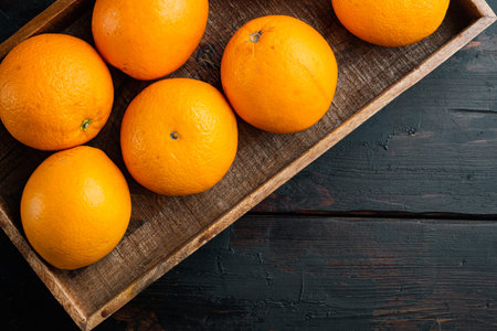 Raw Organic Cara Navel Oranges set, in wooden box, on old dark wooden table background, top view flat lay, with copyspace and space for textの写真素材