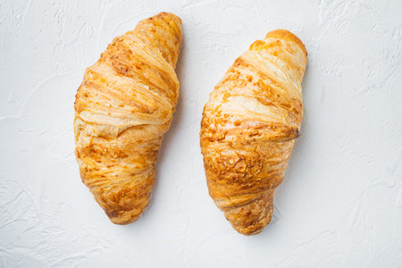 Tasty buttery croissants set, on white stone background, top view flat lay
