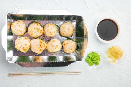 Variety of different sushi and rolls fro, salmon and tuna in delivery food concept set, on white stone background, top view flat layの写真素材