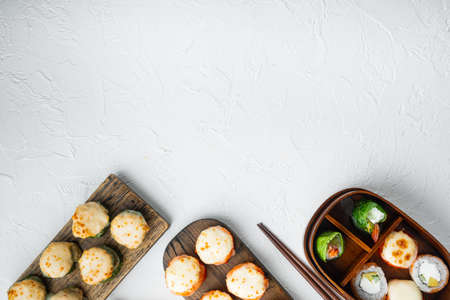 Baked sushi roll with shrimp and masago caviar cap. Traditional sushi restaurant dish set, on white stone background, top view flat lay, with copyspace and space for textの写真素材