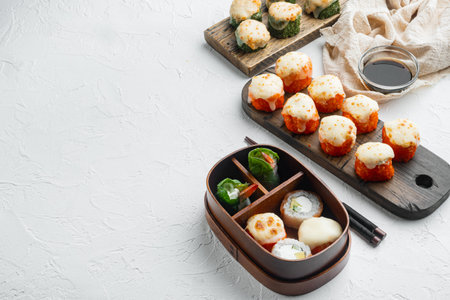 Japanese sushi rolls named Baked Ebi with wasabi and salmon fish set, on white stone background,...
