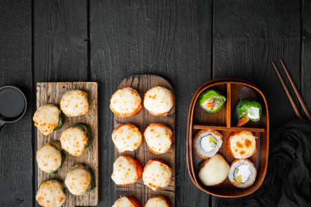Fresh Sushi rolls with wasabi and ginger set, on black wooden table background, top view flat lay, with copyspace and space for textの写真素材