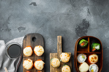 Fresh Sushi rolls with wasabi and ginger set, on gray stone background, top view flat lay, with...
