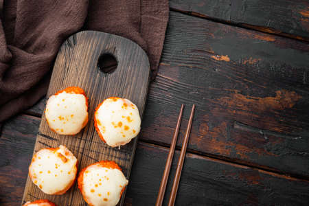 Japanese sushi rolls named Baked Ebi with wasabi and salmon fish set, on old dark wooden table background, top view flat lay, with copyspace and space for textの写真素材