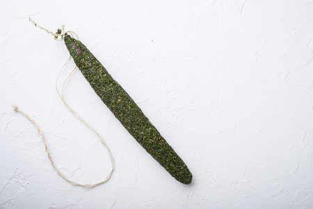 Fuet, salami sausages on white background, topview with space for text.