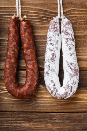 Traditional spanish smoked sausages meat hanging on wood table.の写真素材