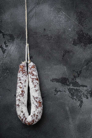 Dry salami sausage fuet on gray background with space for text.の写真素材