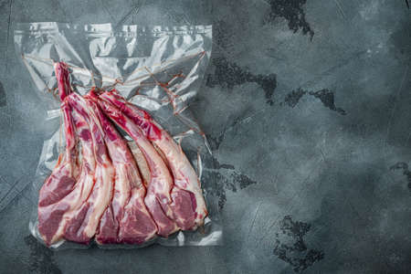 Vacuum sealed fresh lamb chops for sous vide set, on gray stone background, top view flat lay, with copyspace and space for textの写真素材