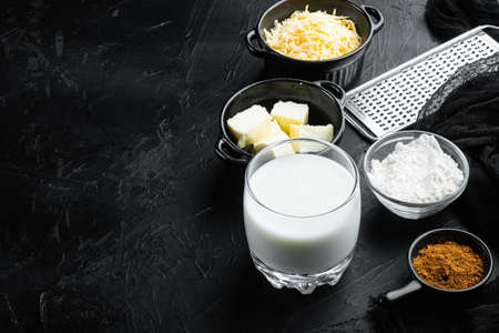 Homemade French Bechamel or White Sauce ingredients set, on black stone background, with copy space for textの写真素材
