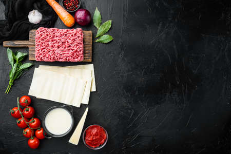 Raw lasagna ingredients and pasta set, on black stone background, top view, flat lay, with copy space for textの写真素材