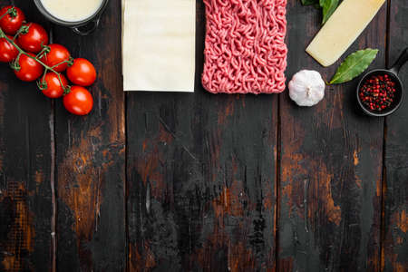 Raw lasagna ingredients and pasta set, on old dark wooden table background, top view, flat lay, with copy space for textの写真素材