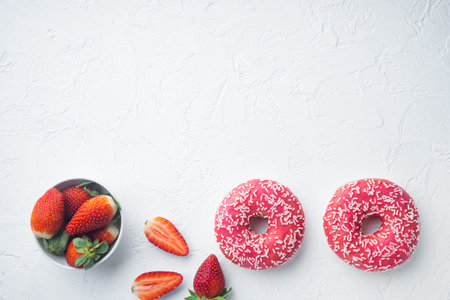 Bitten strawberry donuts, on white background, top view flat lay with copy space for textの写真素材