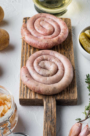 Raw snail sausage in traditional spiral set, on white backgroundの写真素材