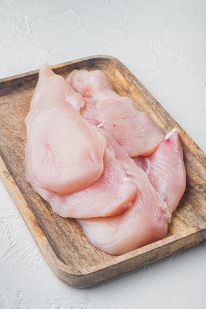 Raw organic chicken breasts, on white backgroundの写真素材