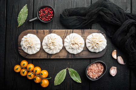 Raw dumplings Dim Sum set, on black wooden table background, top view flat layの写真素材