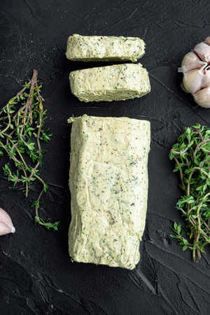 Farm Butter with a herb for sandwiches and steak set, on black stone background