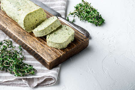 Portion of Herb Butter with Chives, Basil, Oregano, Parsley set, on white stone background, with copy space for textの写真素材
