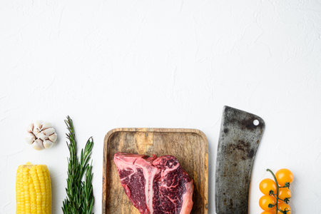 Big raw porterhouse steak with spices and ingredients set, on white stone background, top view flat lay, with copy space for textの写真素材