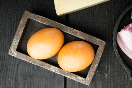 Raw egg set, on black wooden background, top view flat layの写真素材