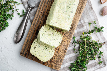 Homemade Herb Butter with garlic set, on white stone background