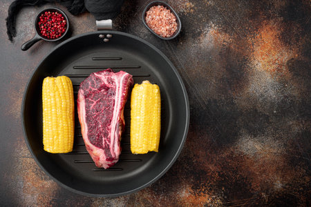 Raw club steak with ingredients set, on old dark rustic background, top view flat lay, with copy space for textの写真素材