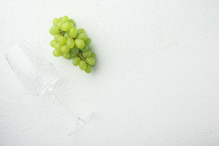 Red and white grapes set, green fruits, on white stone background, top view flat lay, with copy space for textの写真素材