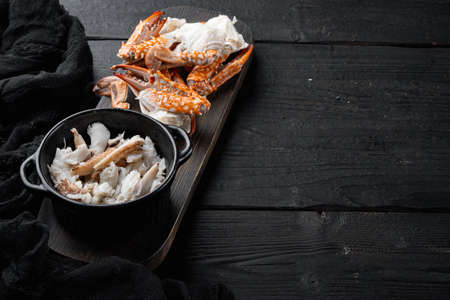 Boiled blue swimming crab claws set, on black wooden table background, with copyspace and space for textの写真素材