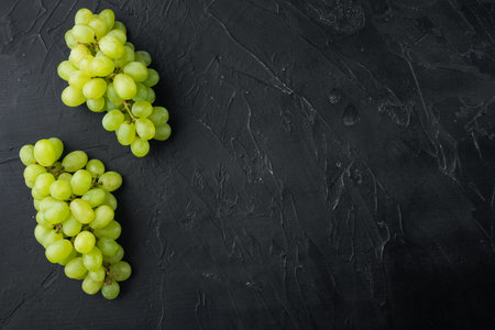 Natural organic juicy grapes set, green fruits, on black stone background, top view flat lay, with...