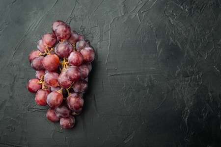 Ripe grape set, dark red fruits, on black stone background, top view flat lay, with copy space for textの写真素材