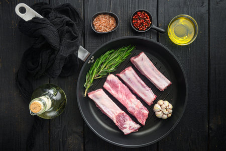 Fresh raw pork meat from organic farm with spices set, in cast iron frying pan, top view flat lay
