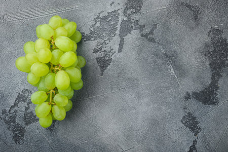 Natural organic juicy grapes set, green fruits, on gray stone background, top view flat lay, with copy space for textの写真素材