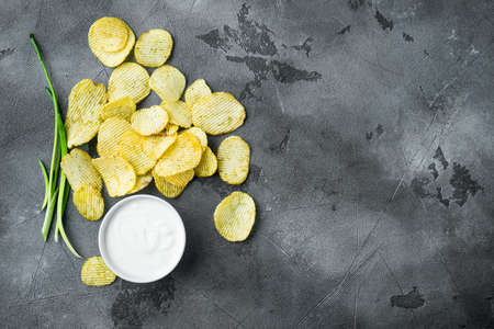 Potatoe chips set, with dipping sauces, on gray stone background, top view flat lay, with copy space for textの写真素材