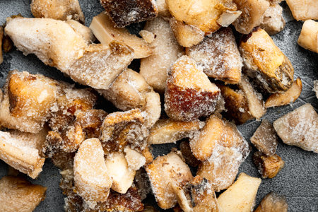 Frozen wild mushrooms set, on gray stone background, top view flat lay