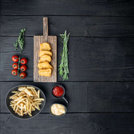 Crispy chicken nuggets meat on black wooden table, top view, with copy space.の写真素材