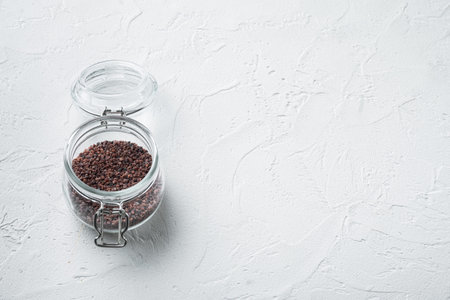 Indian Black salt, Kala namak hindi Healthy food concept set, in glass jar, on white stone...