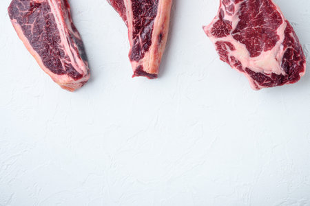Variety of Raw Black Angus Prime Dry aged meat steaks set, tomahawk, t bone or porterhouse and club...
