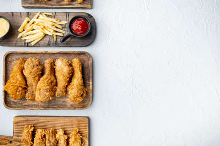 Crispy fried chicken parts on white background, flat lay, with copy space.の写真素材